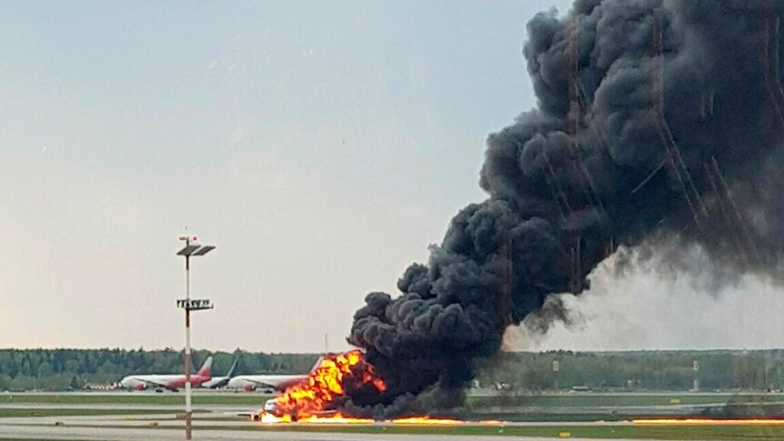 Thick black smoke rises from a plane fire in Moscow's Sheremetyevo airport.