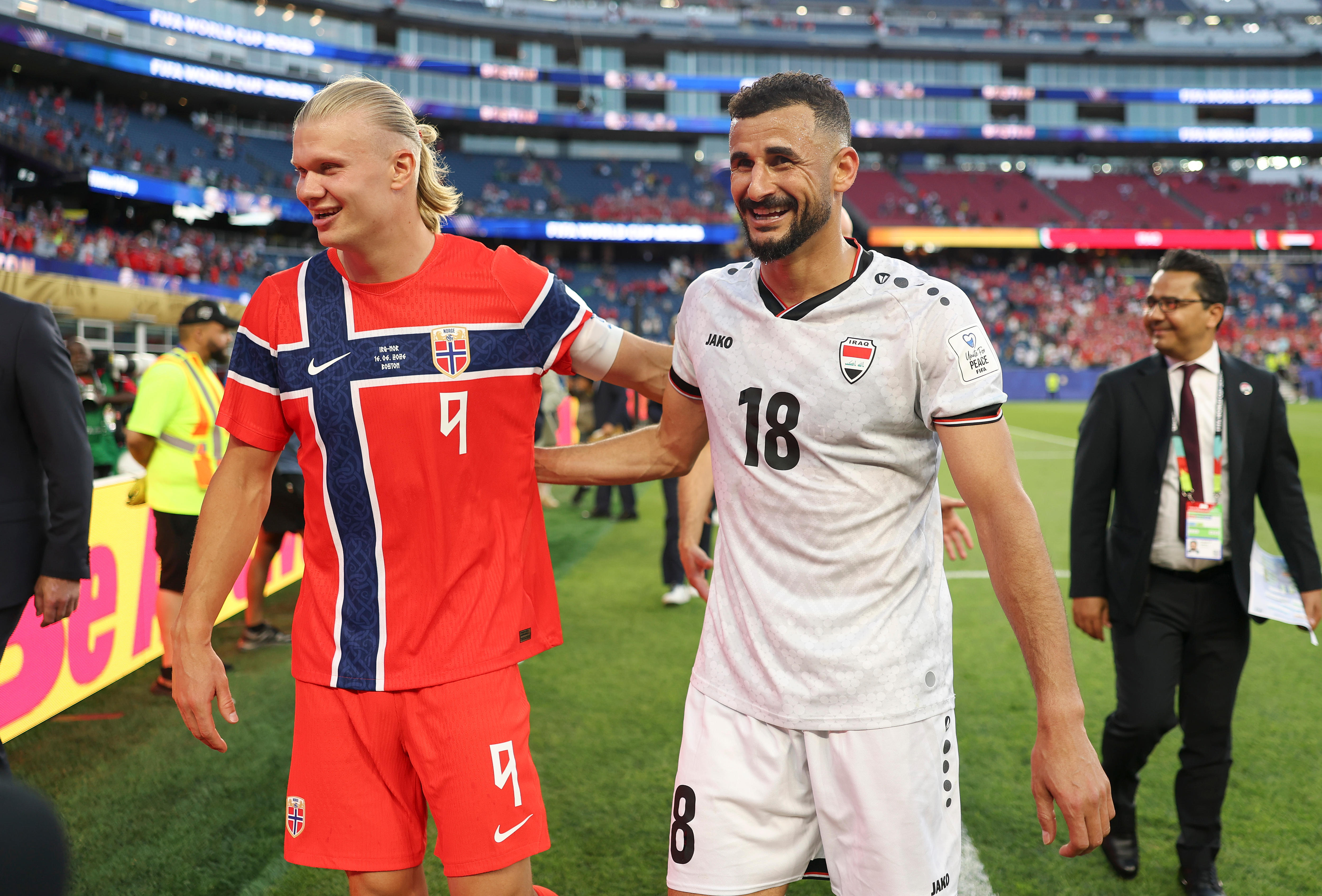 Erling Haaland and Aymen Hussein embrace after World Cup match.