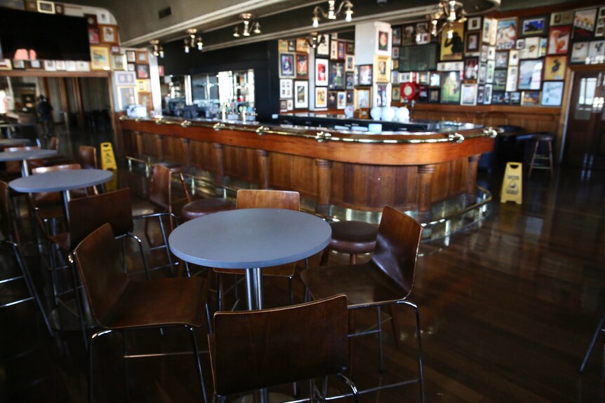 Tables and chairs are empty in the old front bar at the Windsor Hotel in South Perth.