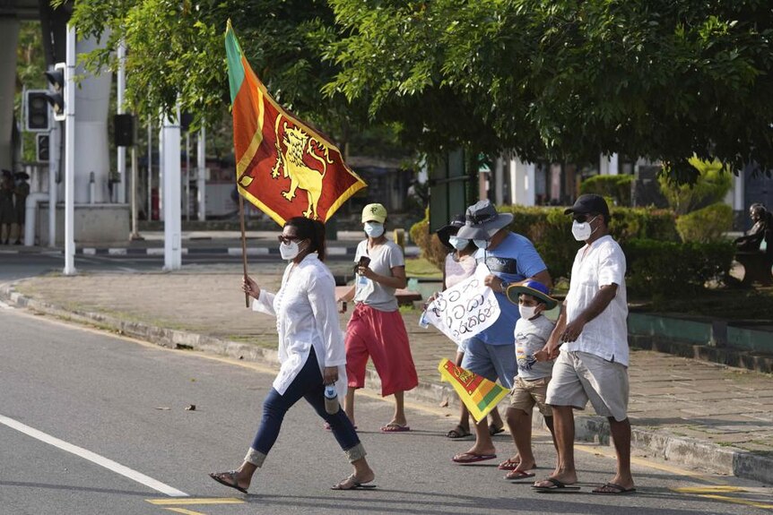 A Sri Lankan family joins a protest demanding resignation of the government during a curfew in Colombo.