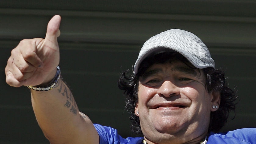 Diego Maradona gives his thumb up to fans at La Bombonera stadium.