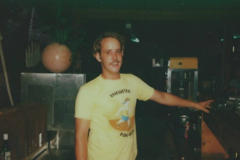 A young Jim Androl wears a yellow Enewetak Fun Run shirt.