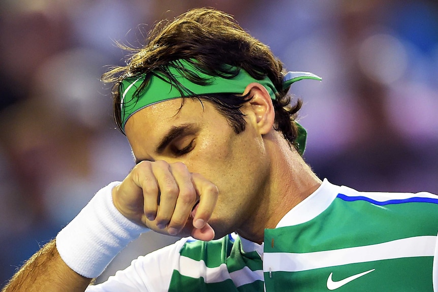 Tough night ... Roger Federer takes a moment to reflect during his quarter-final against Novak Djokovic