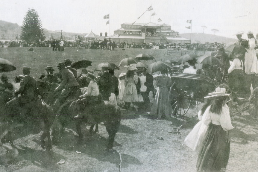 A black and white historic image of crowds at a show in the early 1900s