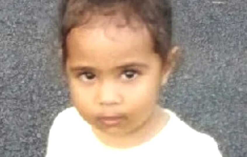 A little girl staring at the camera.