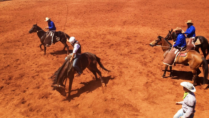 Jillaroo Nicole from Minderoo Station cracks her whip in the Station Buck Jump event at the 20th Pannawonica Rodeo.