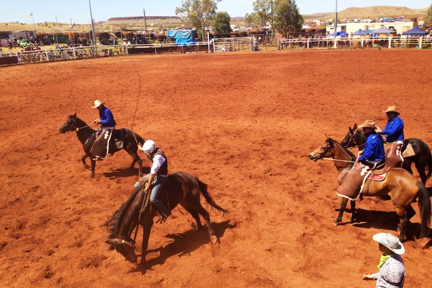 Jillaroo Nicole from Minderoo Station cracks her whip in the Station Buck Jump event at the 20th Pannawonica Rodeo.