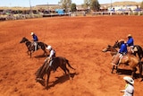 Jillaroo Nicole from Minderoo Station cracks her whip in the Station Buck Jump event at the 20th Pannawonica Rodeo.