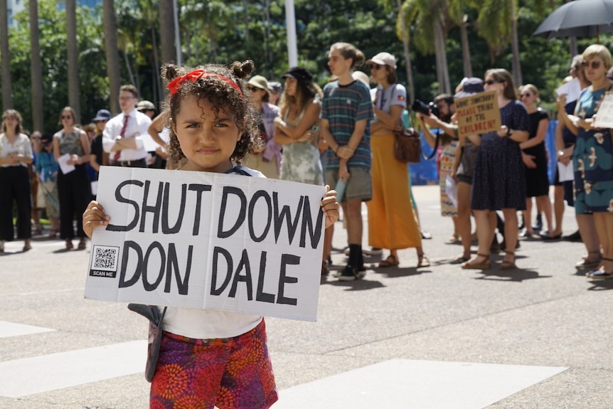 A young girl holds up a 'close Don Dale' sign at a protest against changes to youth bail laws in the NT.