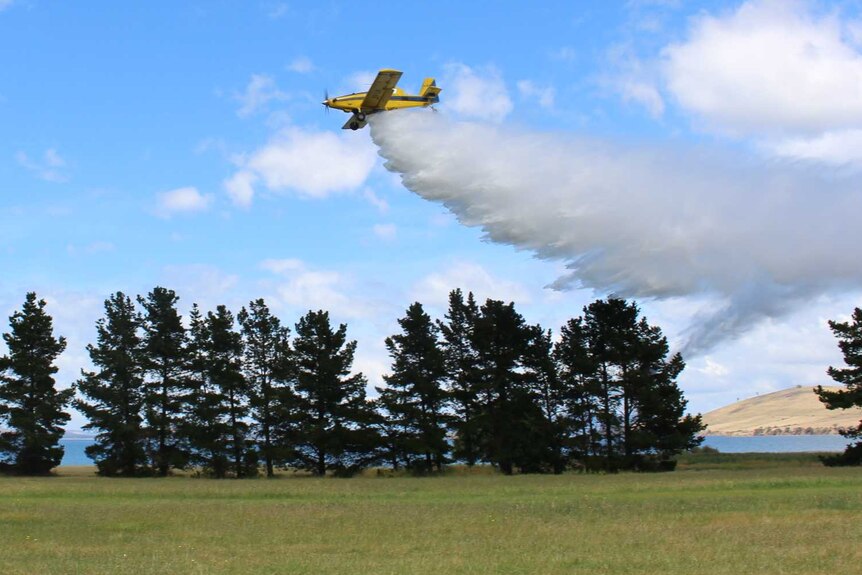 Fire fighting plane drops water