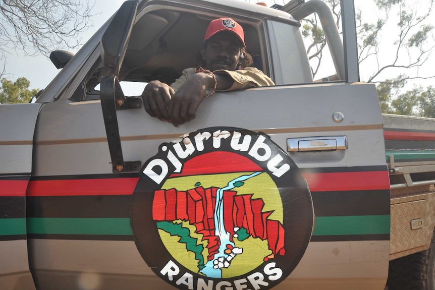 Ranger Allio Djandjul sits in a car