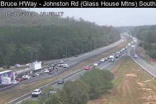 A traffic camera captures the crash and a building jam on the Bruce Highway, near the Glass House Mountains.