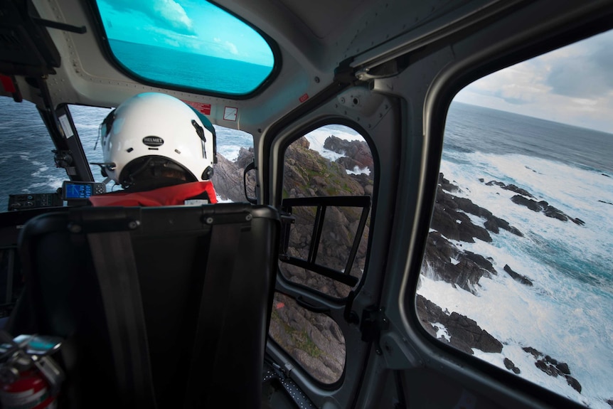 A helicopter pilot flies over remote Albatross Island off Tasmania's coast.