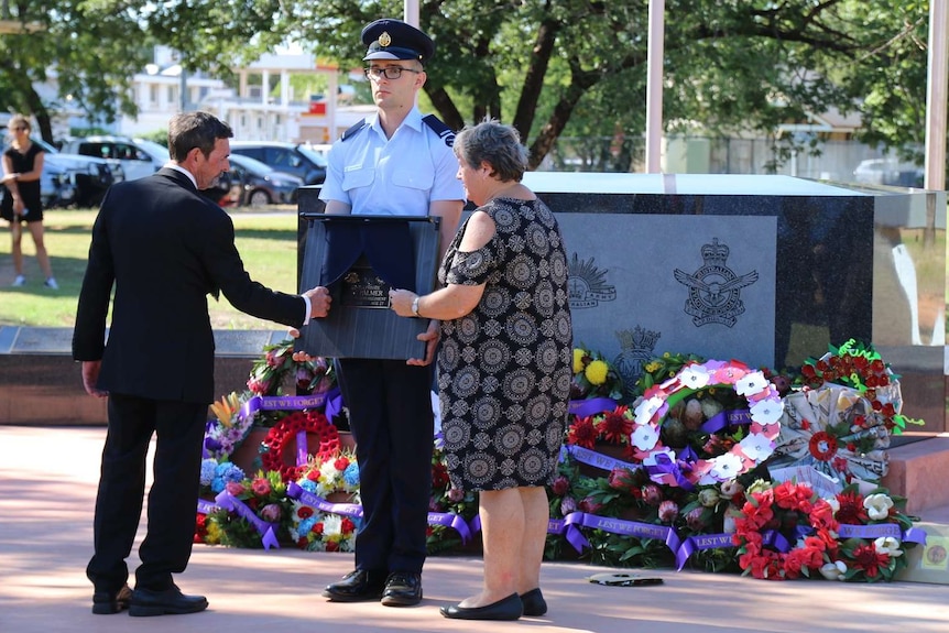 Ray and Pam Palmer unveil the new plaque to commemorate the life of their son killed in Afghanistan, Scott Palmer.