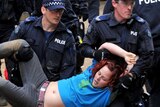 An Occupy Melbourne protester is removed at City Square in Melbourne