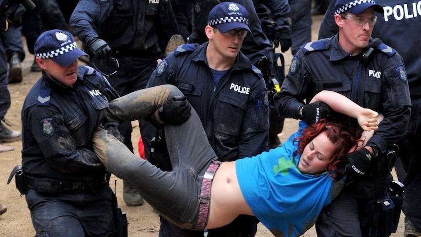 An Occupy Melbourne protester is removed at City Square in Melbourne