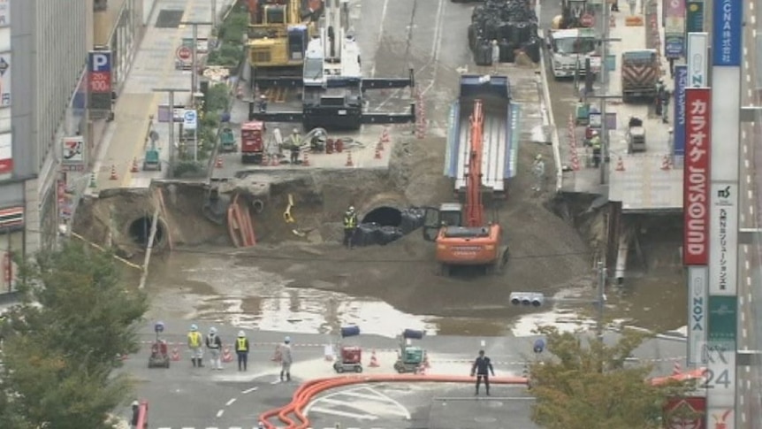 Workers repair giant sinkhole in the Japanese city of Fukuoka.