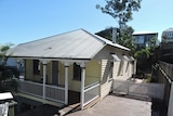 A screenshot from realestate.com.au showing a property up for rent in Paddington, Brisbane, offering a free TV