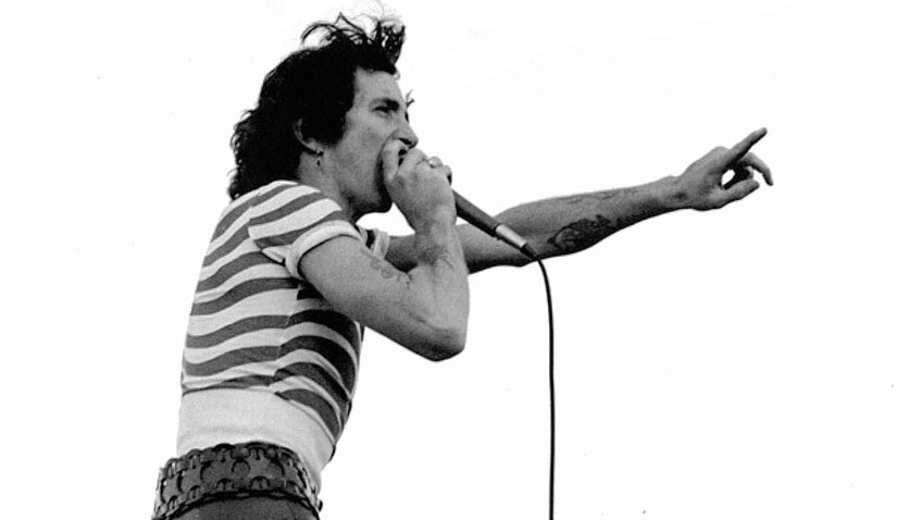 A supplied image of Bon Scott of the rock band AC/DC performing at Victoria Park, Sydney, September 1975.