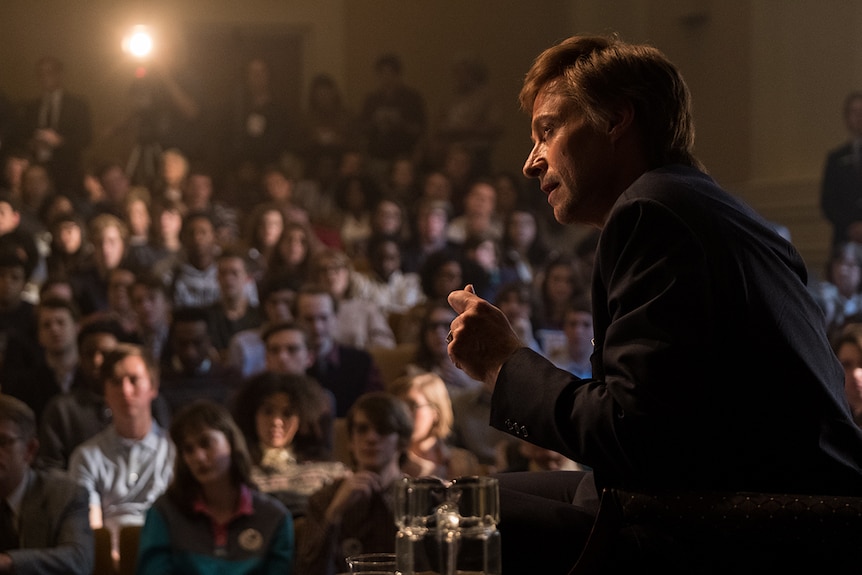 Colour still of Hugh Jackman giving a speech in 2018 film The Front Runner.