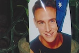 A photo of Billy Hardy sits in a potplant with the Australian flag after the Bali bombings that rocked the Sari nightclub.