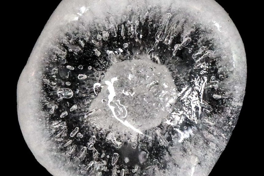 Close up od a large hailstone on a dramatic black background