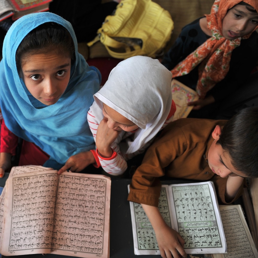 Afghan children attend a Koran reading class at an Islamic school in Kabul on September 4, 2011.