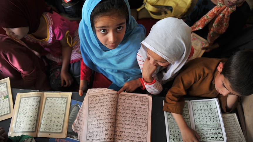 Children attend a Koran reading class at an Islamic school in Kabul