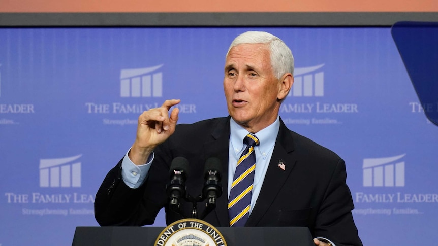 Mike Pence speaks from behind a lectern.