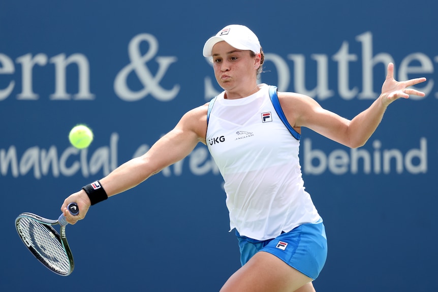 Ash Barty puffs out her cheeks as she unleashes a forehand
