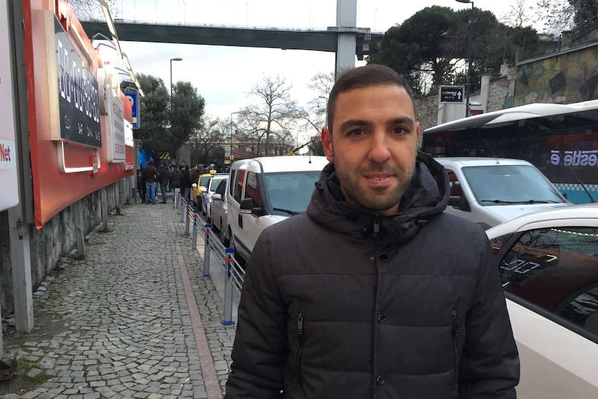 Thirty-year-old man John Canuyar stands on a street in Istanbul.