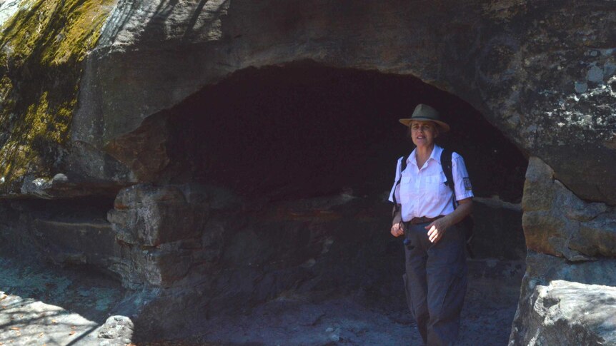 Aboriginal education officer, Karen Smith, in a rock shelter at Balls Head reserve in North Sydney.