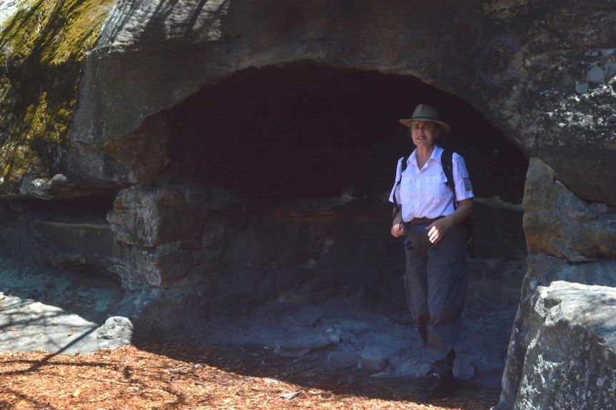 Aboriginal education officer, Karen Smith, in a rock shelter at Balls Head reserve in North Sydney.