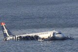 Passengers stand on the wings of a US Airways plane after it ditched in the Hudson River
