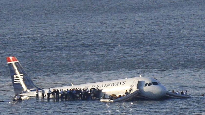 Passengers stand on the wings of a US Airways plane after it ditched in the Hudson River