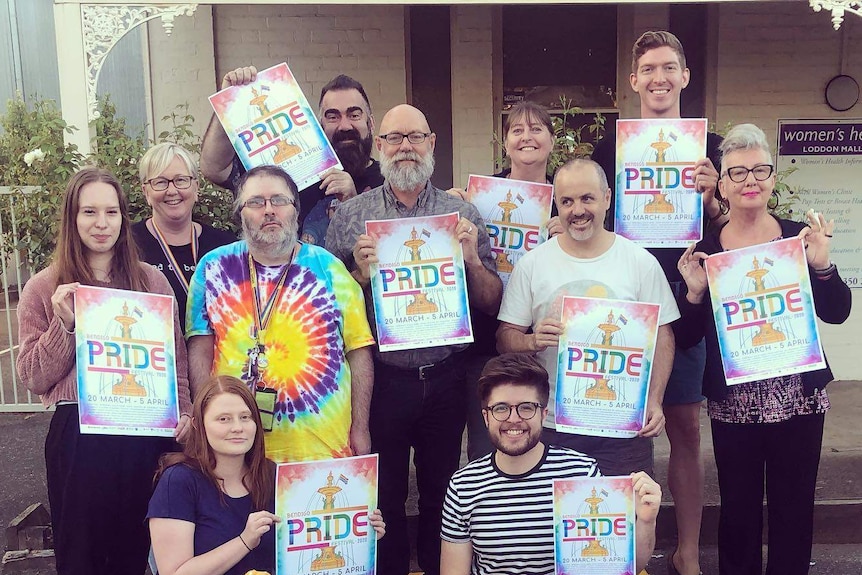 A group of people holding pride posters