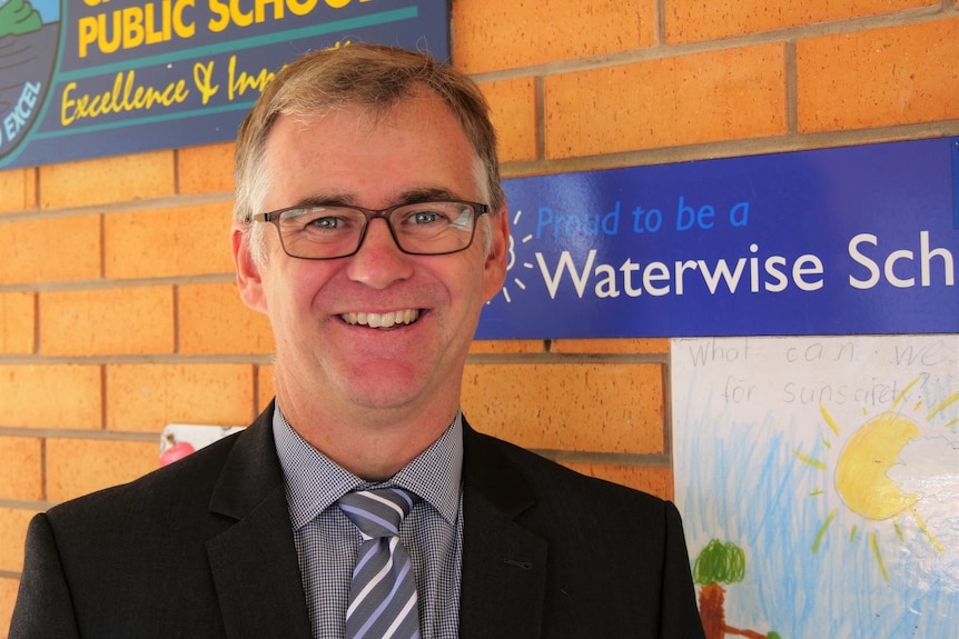 A man standing outside Crescent Head Public School.