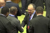 MPs shake hands with and congratulate Peter O’Neill on securing a second term as Prime Minister.