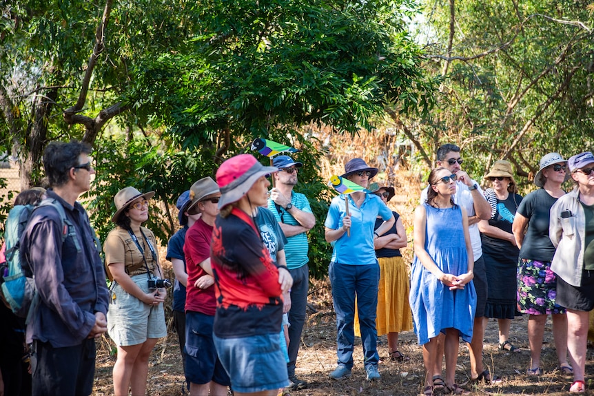 A group of people stand at a rally at Lee Point