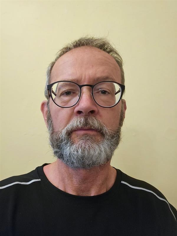Close up portrait of a man wearing glasses.