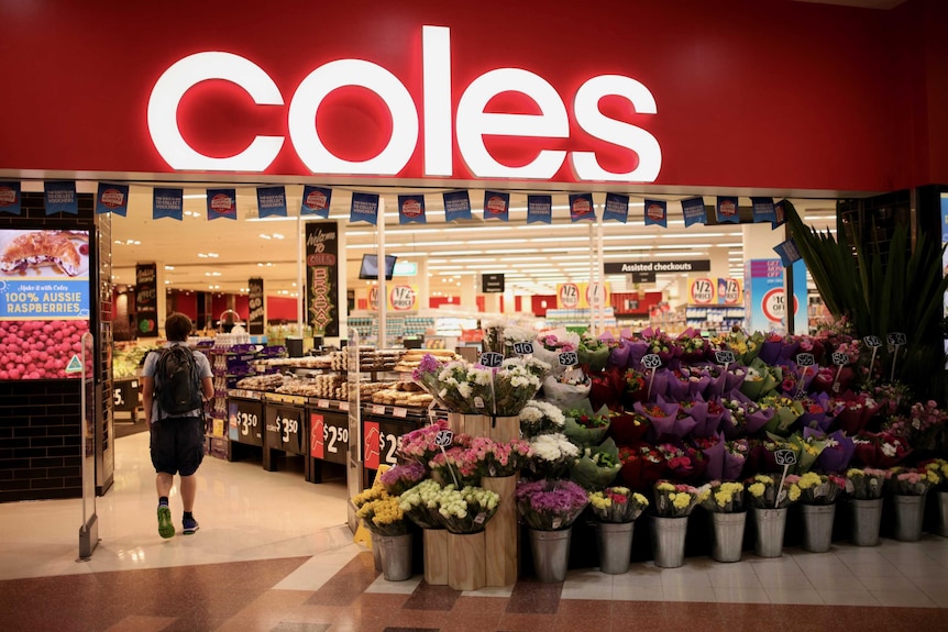 The entrance of a Coles supermarket with flowers out the front