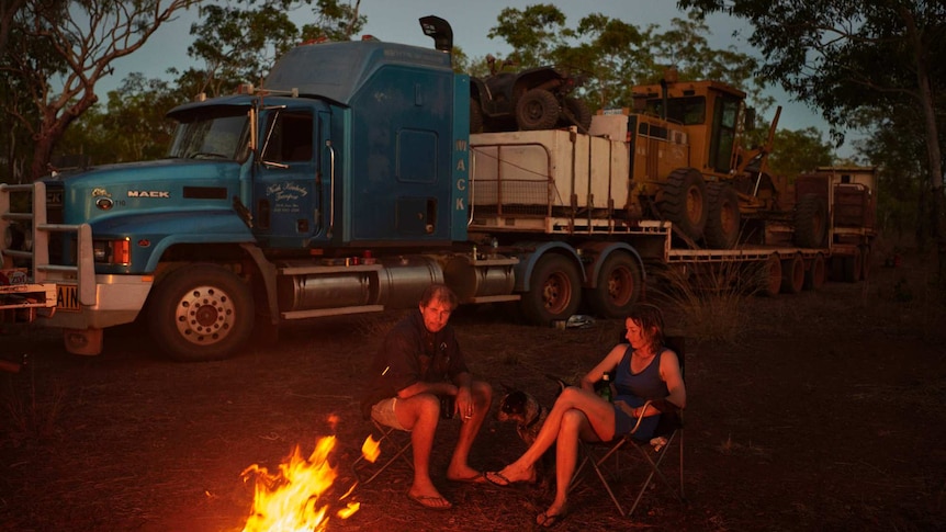 Nick and Joanna Atkins with their dog Lin sit by the campfire after a day of driving the Gibb River-Kalumburu Road