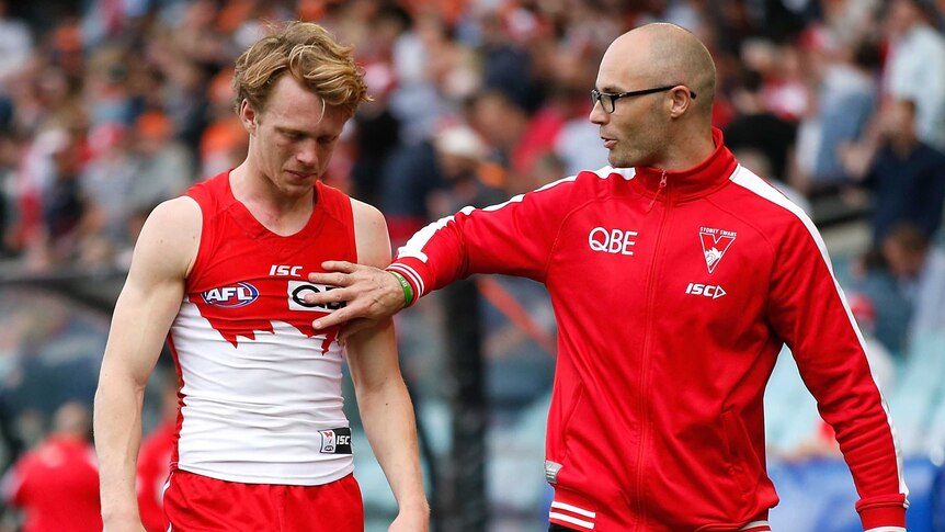 Sydney's Callum Mills (L) comes off after being injured in the qualifying final against GWS.