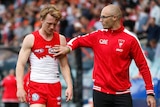 Sydney's Callum Mills (L) comes off after being injured in the qualifying final against GWS.