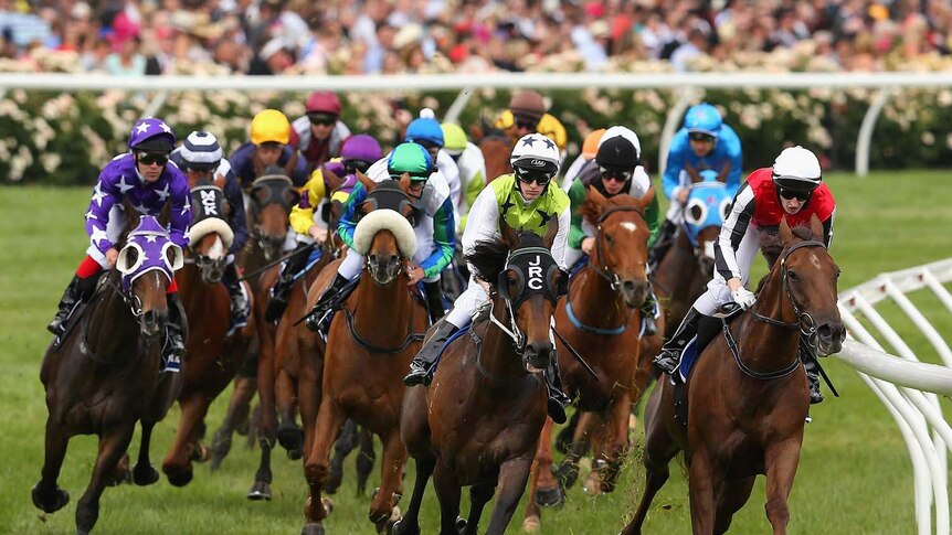 Horses round the bend in race three on Melbourne Cup day