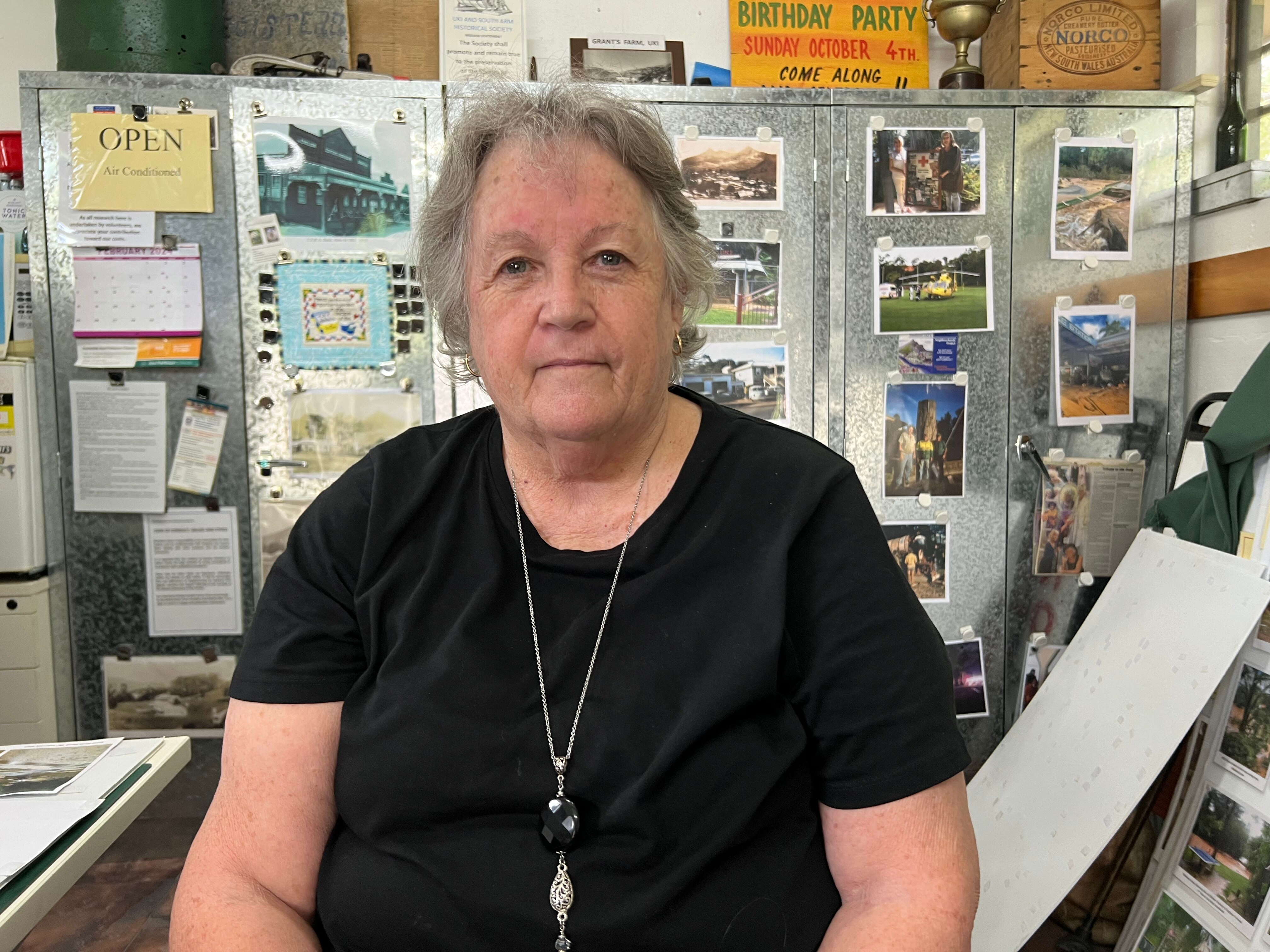 A man in an office holding up a document titled draft options paper.