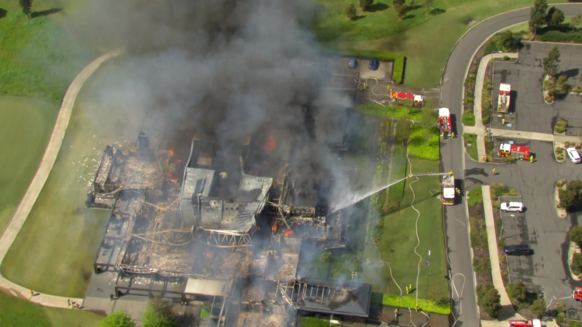 A building on fire at a golf course