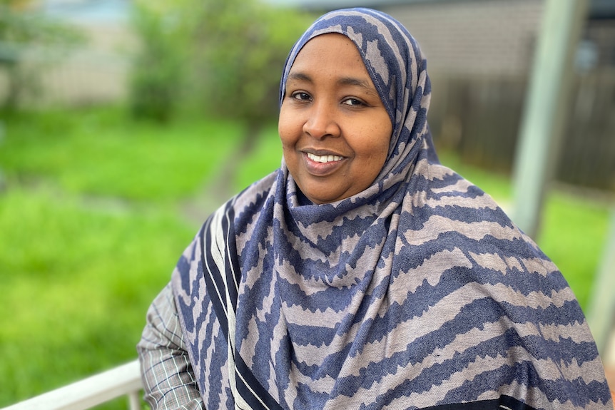 Anaab Rooble looks at the camera while standing on her back porch. Ausnew Home Care, NDIS registered provider, My Aged Care