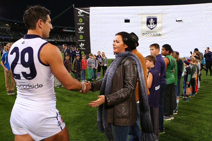 Matthew Pavlich of the Dockers greets Marite Norris, mother of MH17 crash victims Evie, Mo and Otis Maslin.