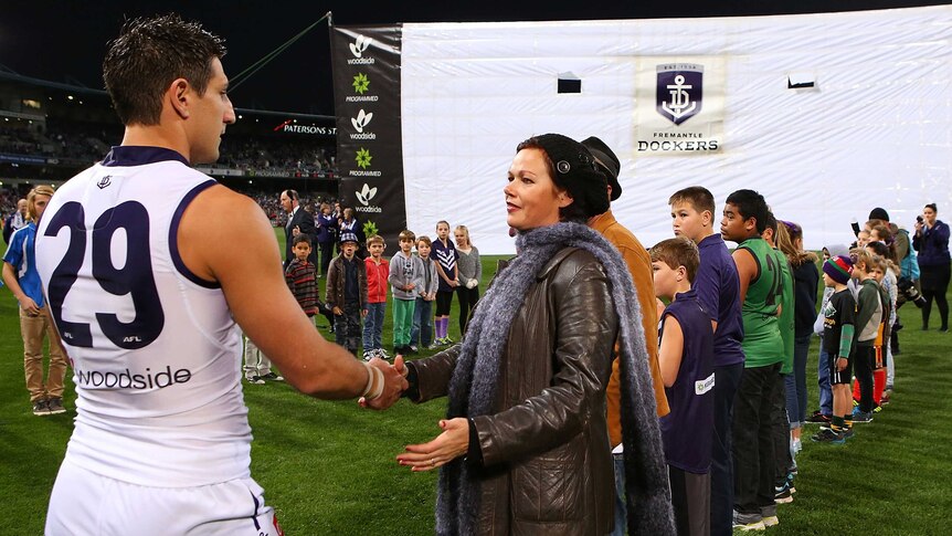 Matthew Pavlich of the Dockers greets Marite Norris, mother of MH17 crash victims Evie, Mo and Otis Maslin.